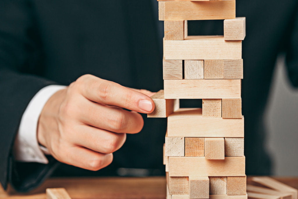 Man and wooden cubes on table. Management concept Man and wooden cubes on table. Management and marketing concepts