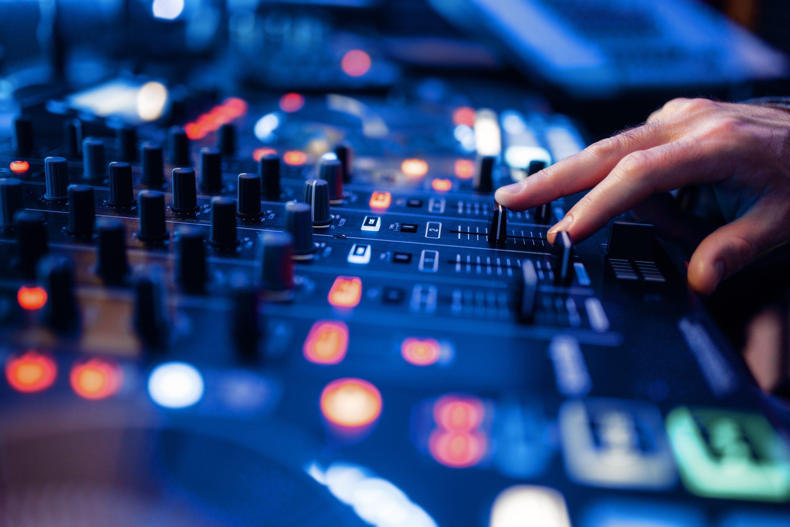Sound operator hands at the volume control panel Sound operator hands at the volume control panel in the recording studio. Musician at the mixer, professional audio mixing